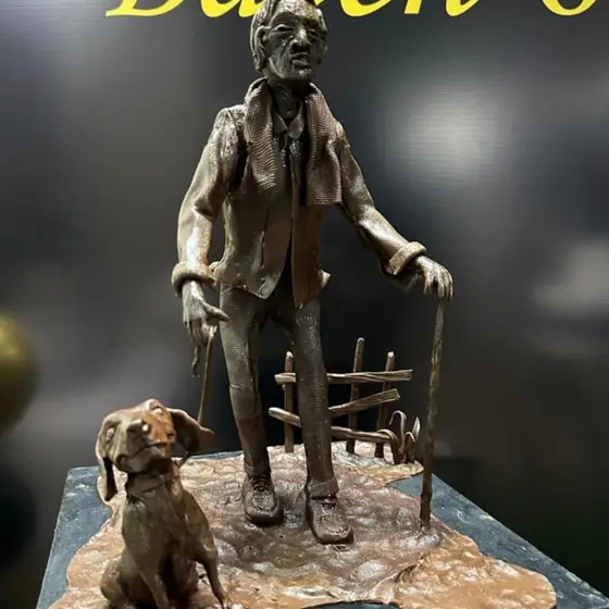 Chocolate modeling paste sculpture of a man and his dog