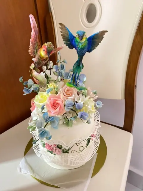 Sugar hummingbirds on a floral cake