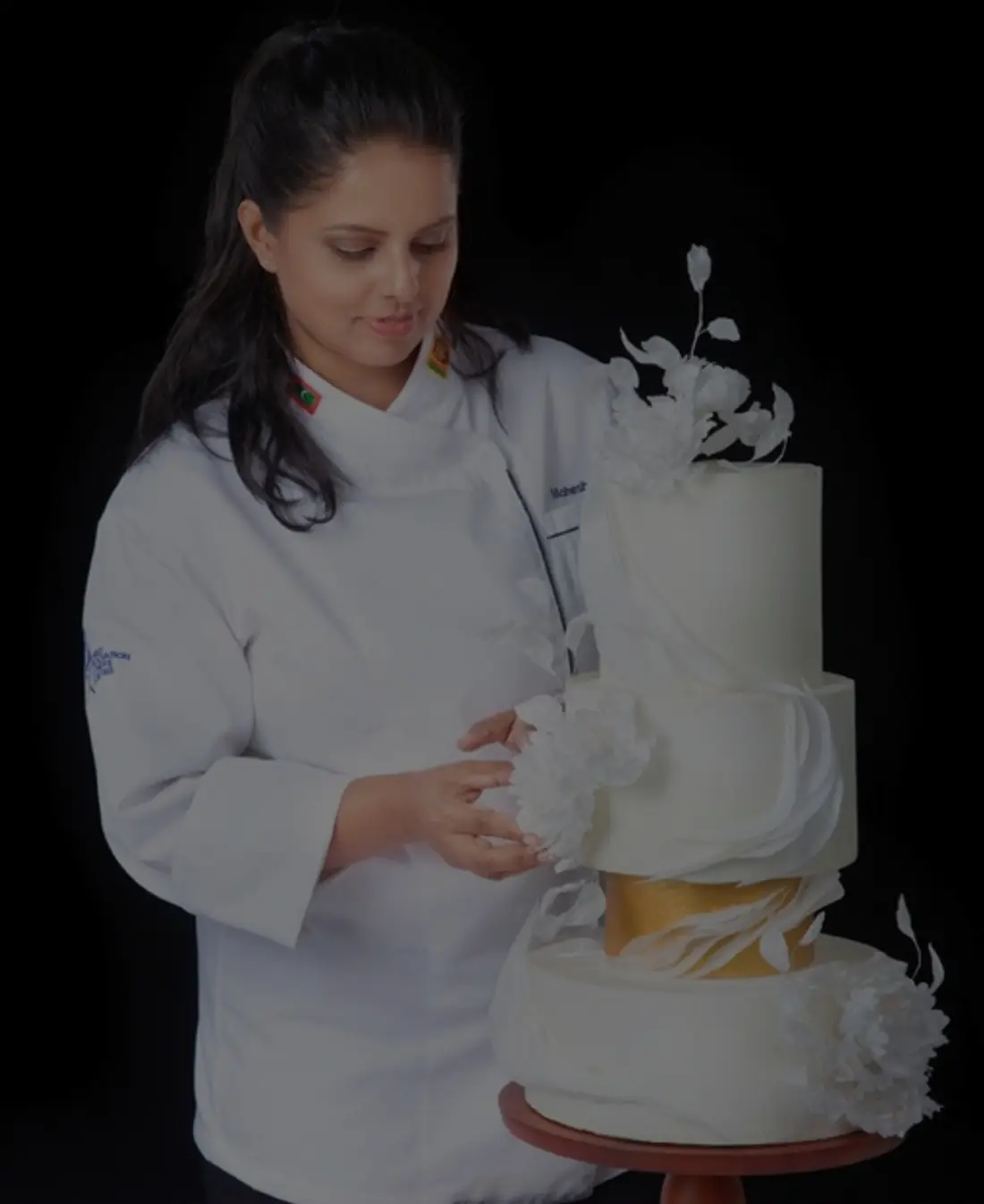 Mash decorating a white tiered wedding cake